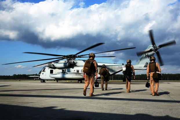Pilots and crew members with Marine Heavy Helicopter Squadron 366 board a CH-53E Super Stallion at Marine Corps Air Station Cherry Point, N.C., Oct. 8, 2014. (U.S. Marine Corps/Cpl. J. R. Heins)