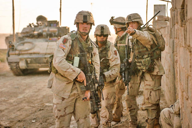 CPT Dean W. Morisson, Executive Officer with the 1st Infantry Divisions 3rd Brigade Reconnaissance Troop, directs SSgt. Nicholus Danielsen while conducting clearing operations in Fallujah Nov. 15, 2004, during Operation Al-Fajr. (1st Lt. Kimberly Snow)