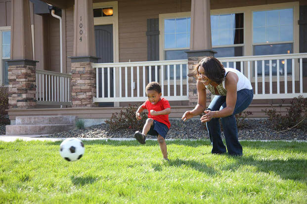 Mother and son playing soccer