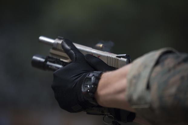 A Force Reconnaissance Marine with Maritime Raid Force, 31st Marine Expeditionary Unit, fires an M1911 .45 caliber pistol in Guam, January 29, 2018, during Visit Board Search and Seizure training (U.S. Marine Corps/Cpl. Bernadette Wildes)