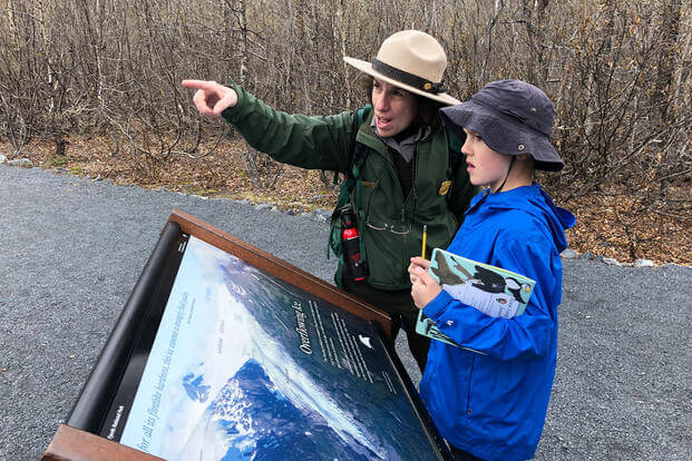 Kenai Fjords National Park Ranger CJ explains the Exit Glacier's recession to a military kid during a Kids to Parks Blue Star Families event in Alaska. (Military.com/Amy Bushatz)