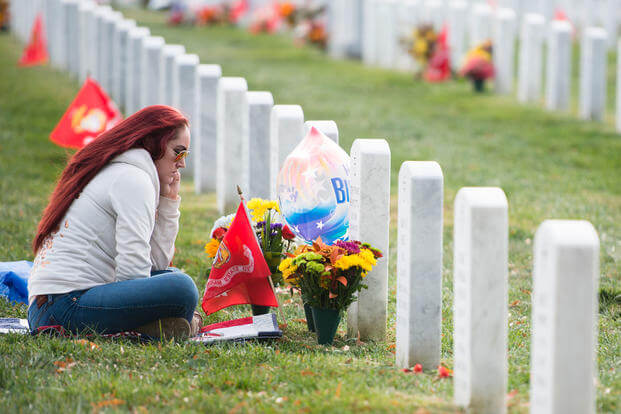 A woman visits her brother's grave in Arlington National Cemetery's Section 60. (U.S. Army/Rachel Larue)