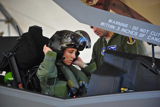 Lt. Col. Christine Mau, the 33rd Operations Group deputy commander, puts on her helmet before taking her first flight in the F-35A Lightning II at Eglin Air Force Base, Fla., on May 5, 2015. Mau, who previously flew F-15E Strike Eagles, made history as the first female F-35 pilot in the program. (U.S. Air Force photo/Staff Sgt. Marleah Robertson)