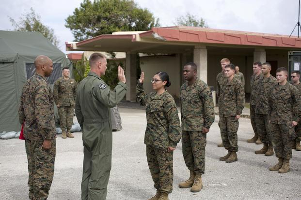 U.S. Marine Corps Lance Cpl. Remedios Cruz, Marine Aircraft Group 12, recites the Oath of Enlistment after being meritoriously promoted at Anderson AFB, Guam, 4 Dec. 2013. (U.S. Marine/Lance Cpl. Richard Currier)
