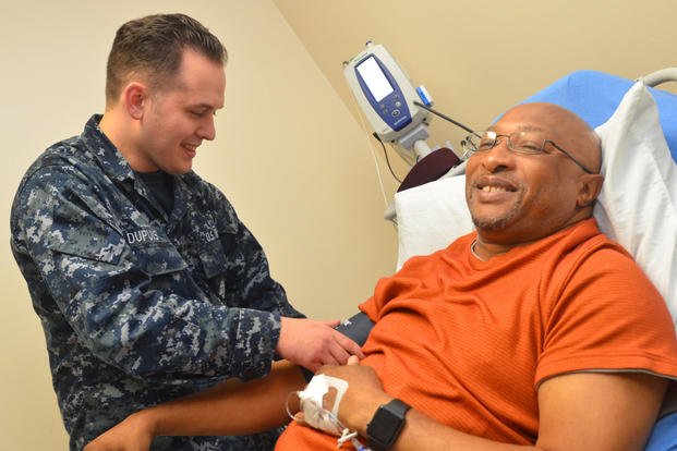Hospitalman Payton Dupuis checks veteran Joseph Levette’s blood pressure at Naval Hospital Jacksonville’s internal medicine clinic, May 10, 2018. (U.S. Navy photo/Jacob Sippel)