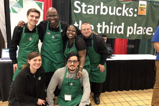 Herrick Ross (back row, center) smiles with a group of Starbucks employees.  (Courtesy of Herrick Ross)