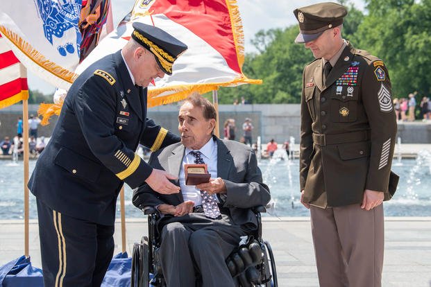 Army Chief of Staff Gen. Mark A. Milley, left, and Sgt. Maj. of the Army Daniel A. Dailey, right, present former Sen. Bob Dole a wooden box with colonel rank in it during a honorary promotion ceremony at the World War II Memorial in Washington, D.C., May 16, 2019. Dole was medically discharged as a captain after being severely wounded in WWII. (U.S. Army photo)