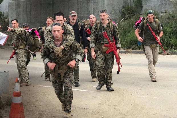 Gunnery Sgt. Andrew Perryman, Dive project officer of Air and Amphibious Systems at Marine Corps Systems Command, carries Staff Sgt. Jonathan Blank during the 11th annual Recon Challenge, at the Reconnaissance Training Company compound on Marine Corps Base Camp Pendleton, California, May 16, 2019. (U.S. Marine Corps photo)