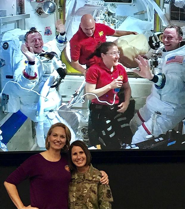 Stacey Morgan, wife of astronaut and Army Col. Drew Morgan, and Air Force Col. Catie Hague, wife of Air Force Col. Nick Hague, share a moment together during a video chat with their spouses and other astronauts aboard the International Space Station. NASA photo