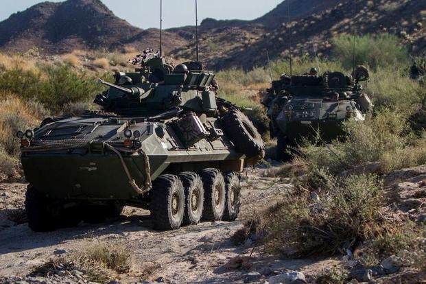 Marines drive light armored vehicles in River Valley, California.