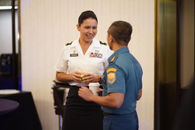 Maj. Tulsi Gabbard, Hawaii Army National Guard military police officer, reviews the operation design process with a Tentara Nasional Indonesia officer during a group break out, Jakarta, Indonesia, August 19, 2019. (Photo by Tech. Sgt. Andrew Jackson/State of Hawaii, Department of Defense, Public Affairs Office)