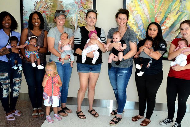 group of women holding babies