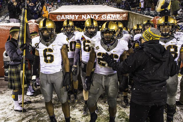 Army players walk out of the locker room after halftime during a game against Navy.