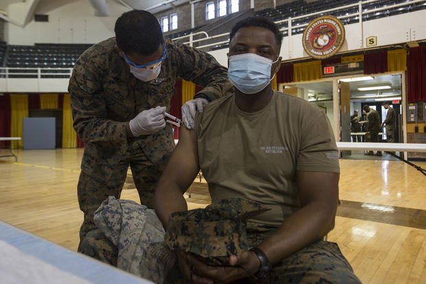 A Marine receives the COVID-19 vaccination.