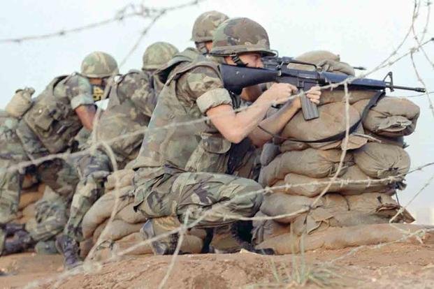U.S. Marines take cover during a firefight in Beirut, 1983. (National Archives)