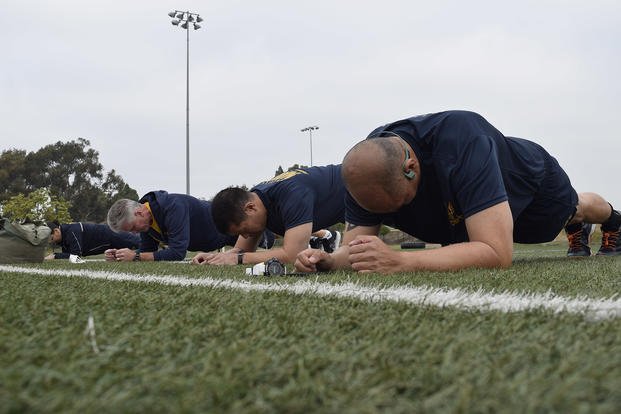 Naval Reserve sailors do the plank exercise as part of the physical readiness test.
