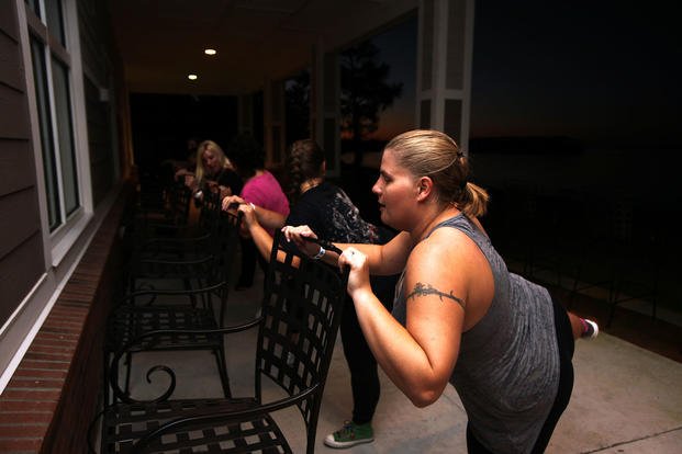 Spouses of active-duty service members participate in a ballet-related aerobic workout.