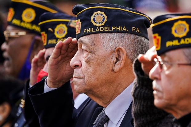 Marine Corps veteran salutes on Veterans Day at the Korean War Memorial in Philadelphia.