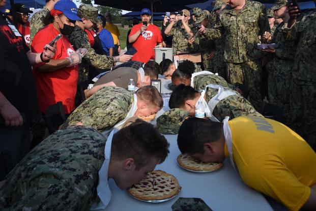 Sailors eat pie at the state fair at Naval Station Great Lakes.