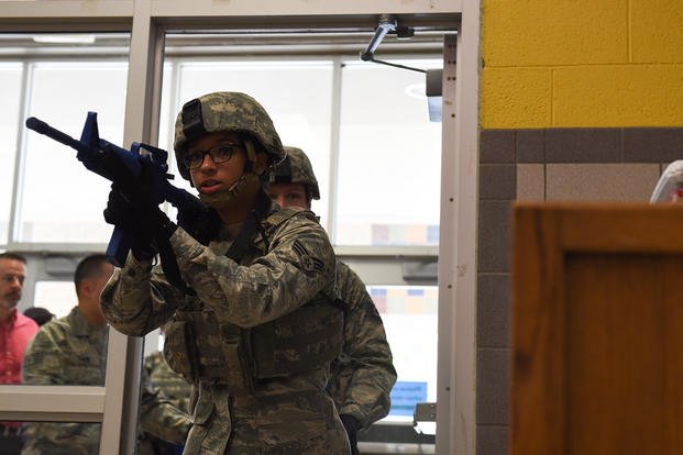 Tech. Sgt. Eric Godinez and Senior Airman Janine Casey search a hallway during an active-shooter exercise at the elementary school on Sheppard Air Force Base, Texas.