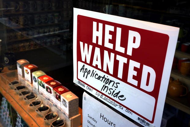 A help-wanted sign hangs in the front window of the Bar Harbor Tea Room in Maine.