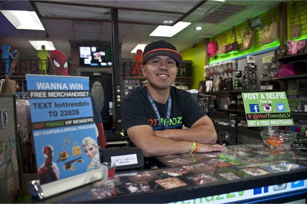 Retired Tech. Sgt. Alfredo Sibucao Jr. poses for a picture inside his retail store in Las Vegas.