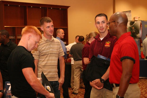 A Department of Labor liaison employment coordinator speaks with wounded, ill and injured Marines from the Wounded Warrior Battalion-West during the Hiring Heroes Career Fair aboard Marine Corps Base Camp Pendleton, Calif.