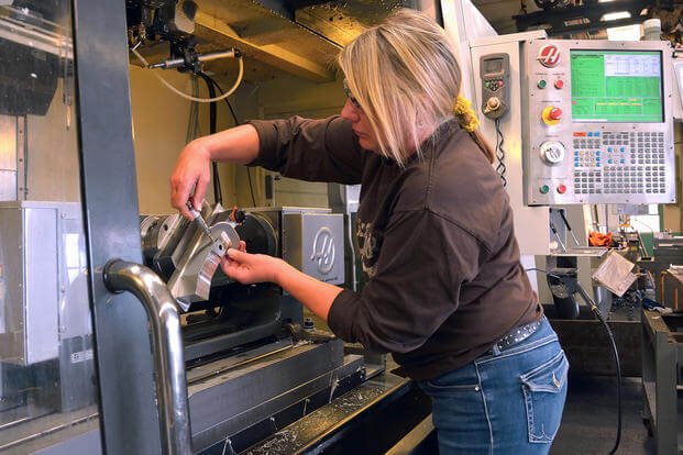 Machinist Margaret Paone works a vertical milling machine to produce a part for the 81mm mortar system at Watervliet Arsenal, N.Y.