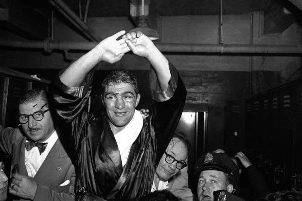 Army veteran Rocky Marciano raises his hands after he was crowned new heavyweight champion with a knockout of Jersey Joe Walcott in Philadelphia.