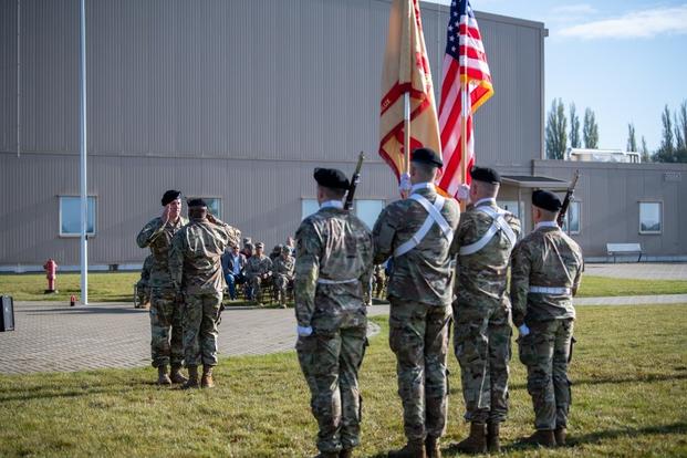 U.S. Army Garrison Benelux Command Sgt. Maj. Gary E. Yurgans exchanges a salute with 1st Sgt. Michael Woodard at the end of the unit's Change of Command Ceremony, on Chièvres Air Base, Belgium, Nov. 05, 2021. 