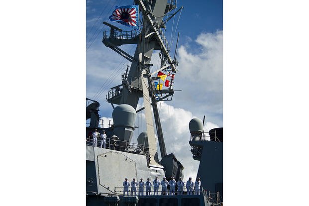 U.S. Navy sailors man the rails as the guided-missile destroyer USS O'Kane departs Joint Base Pearl Harbor-Hickam, Hawaii, for a deployment to the Western Pacific.  