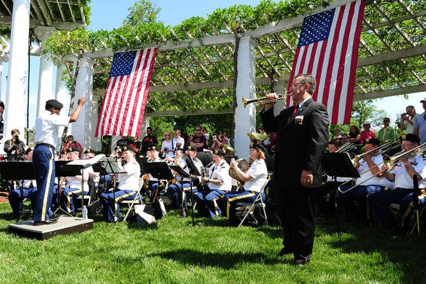 'Taps' historian Jari Villanueva performs the solo piece in 'Taps Eternal Father' with the Maryland Defense Force Band at the Taps 150th Anniversary Ceremony in Arlington National Cemetery. 