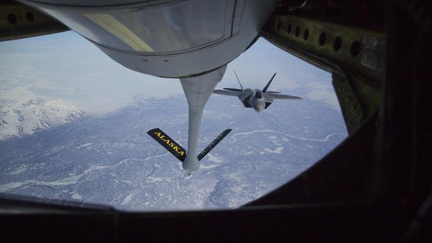 F-22 Raptor jet fighter prepares to hook up to an Alaska Air National Guard KC-135 Stratotanker