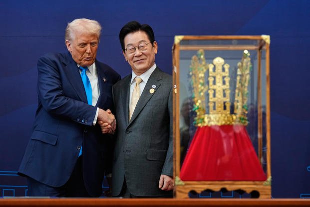 President Donald Trump shakes hands with South Korean President Lee Jae Myung as he receives a gift of a gold crown and an award of the Grand Order of Mugunghwa, not seen, during a high honor ceremony at the Gyeongju National Museum in Gyeongju, South Korea, Wednesday, Oct. 29, 2025. (AP Photo/Mark Schiefelbein) APTOPIX South Korea Trump Asia