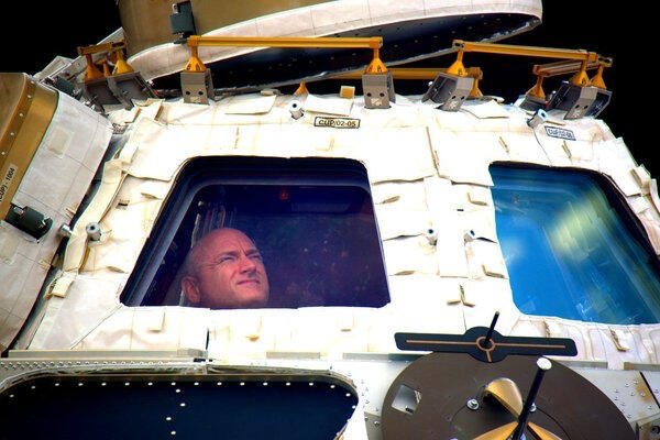 FILE - In this undated photo provided by NASA on Tuesday, March 1, 2016, astronaut Scott Kelly looks out the cupola of the International Space Station. (NASA via AP, File) Space Station-25th Anniversary