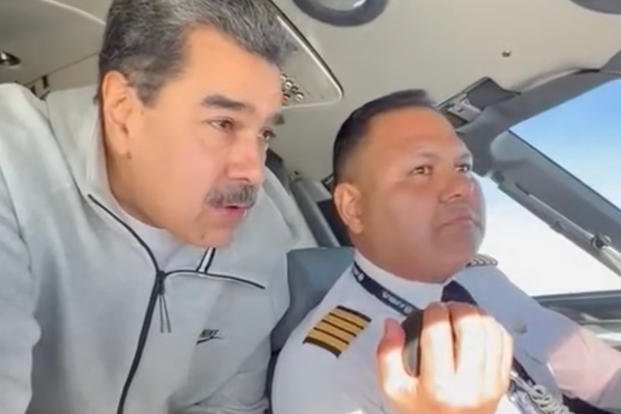 In this image made from a video posted on the Facebook account of Venezuelan President Nicolás Maduro on Dec. 15, 2023, Maduro stands behind pilot Gen. Bitner Villegas in the cockpit of an airplane. (AP Photo) US Maduro Pilot