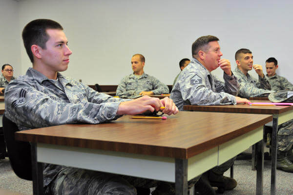 Airmen taking tests at their desks in a class.