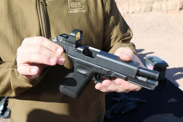Kyle Hopp, commercial manager for Glock, shows off the company's new Modular Optic System, or MOS, Jan. 18, 2016, at SHOT Show's range day outside Las Vegas. (Photo by Brendan McGarry/Military.com)