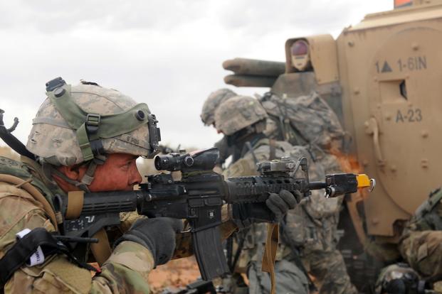 A soldier assigned to 1st Battalion, 6th Infantry Regiment, 2nd Brigade Combat Team, 1st Armored Division, fires a M4 carbine weapon during urban warfare training May 22, 2017, at Orogrande, N.M. Staff Sgt. Elizabeth Tarr/Army
