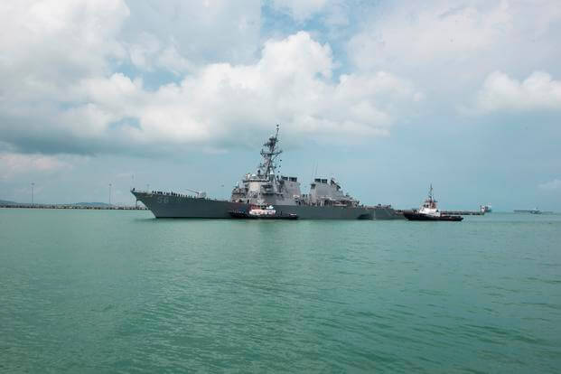 Tugboats assist the USS John S. McCain (DDG 56) at it steers towards Changi Naval Base in Singapore following a collision with the merchant vessel Alnic MC east of the Straits of Malacca and Singapore on Aug. 21, 2017 (U.S. Navy photo/Joshua Fulton)