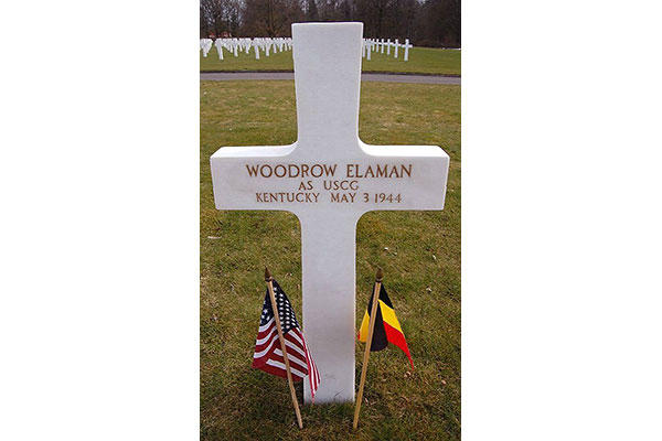 The grave of Woodrow Elaman, USCG, at the Ardennes American Cemetery in Neupre, Belgium, who was killed in action during World War II. Members of Coast Guard Activities Europe have adopted his grave. (American Battle Monuments Commission photo)