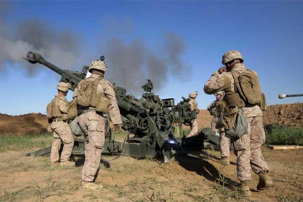U.S. Marines with Task Force Spartan, 26th Marine Expeditionary Unit (MEU), on Fire Base Bell, Iraq, fire an M777A2 Howitzer at an ISIS infiltration route March 18, 2016.  (Photo By: Cpl. Andre Dakis)