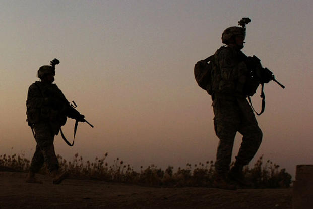 In a 2007 file photo, soldiers with 2nd Brigade Combat Team, 101st Airborne Division (Air Assault), move toward an objective while searching for detonation cord after an IED detonated in Iskandariyah, Iraq. Army photo