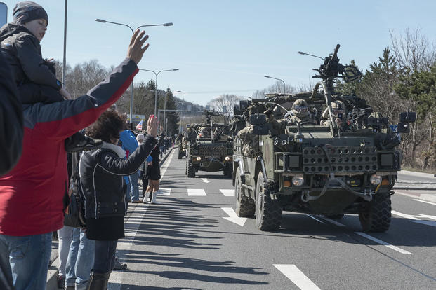 Citizens greet Battle Group Poland as a tactical vehicle convoy crosses into Poland March 26, 2017. U.S. Army 2nd Squadron, 2nd Cavalry Regiment, and other nations are deployed as part of NATO's Enhanced Forward Presence. Sgt. 1st Class Patricia Deal/Army