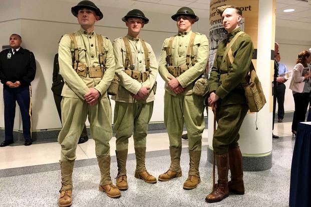 Dressed in WWI uniforms, members of the 3rd U.S. Infantry Regiment, “The Old Guard,” stand next to historian Todd Rambow at the Pentagon following a ceremony to commemorate the 100th anniversary of the U.S. miliary entering WWI.(Matt Cox/Military.com)