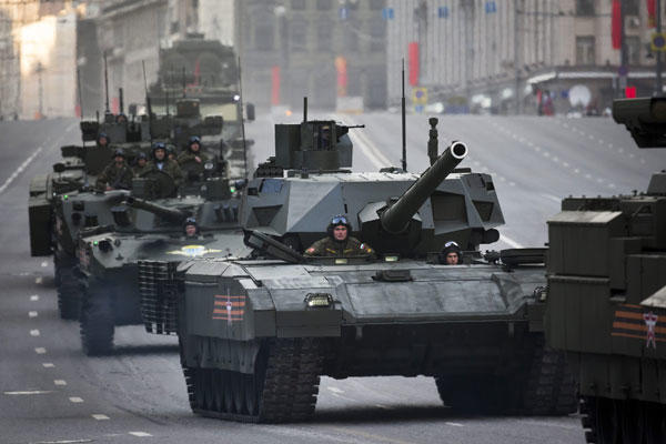 Russian military vehicles including the new Russian T-14 Armata tank, center, make their way to Red Square during a rehearsal for the Victory Day military parade in Moscow, Russia, Monday, May 4, 2015.(AP Photo/Alexander Zemlianichenko)