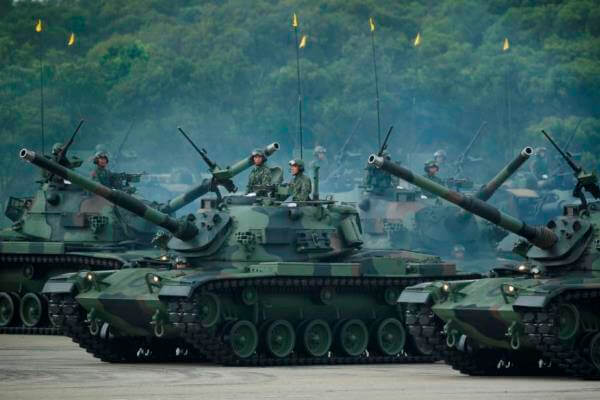 Taiwan's military maneuver battle tanks in front of thousands of spectators in a parade marking the 70th anniversary of the end of WWII, at the military base in Hsinchu, northern Taiwan, Saturday, July 4, 2015. AP