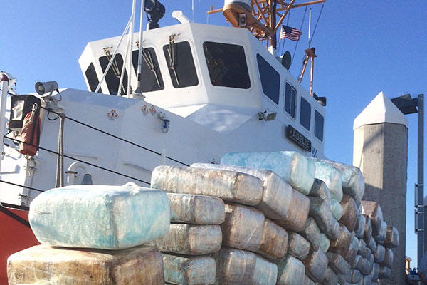 Bales of interdicted marijuana are stacked on the pier in San Diego in front of the Coast Guard Cutter Adelie Aug. 29, 2015. (U.S. Coast Guard Photo)