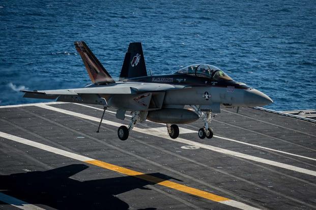 An F/A-18F Super Hornet assigned to the Black Knights of Strike Fighter Squadron (VFA) 154 lands on the flight deck of the aircraft carrier USS Nimitz (CVN 68). (U.S. Navy/Mass Communication Specialist 3rd Class Raul Moreno Jr.)