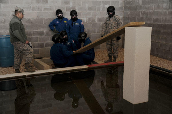 Six American and international astronauts work together to overcome an obstacle at the Project X leadership reaction course March 4, 2014, at Maxwell Air Force Base, Ala.